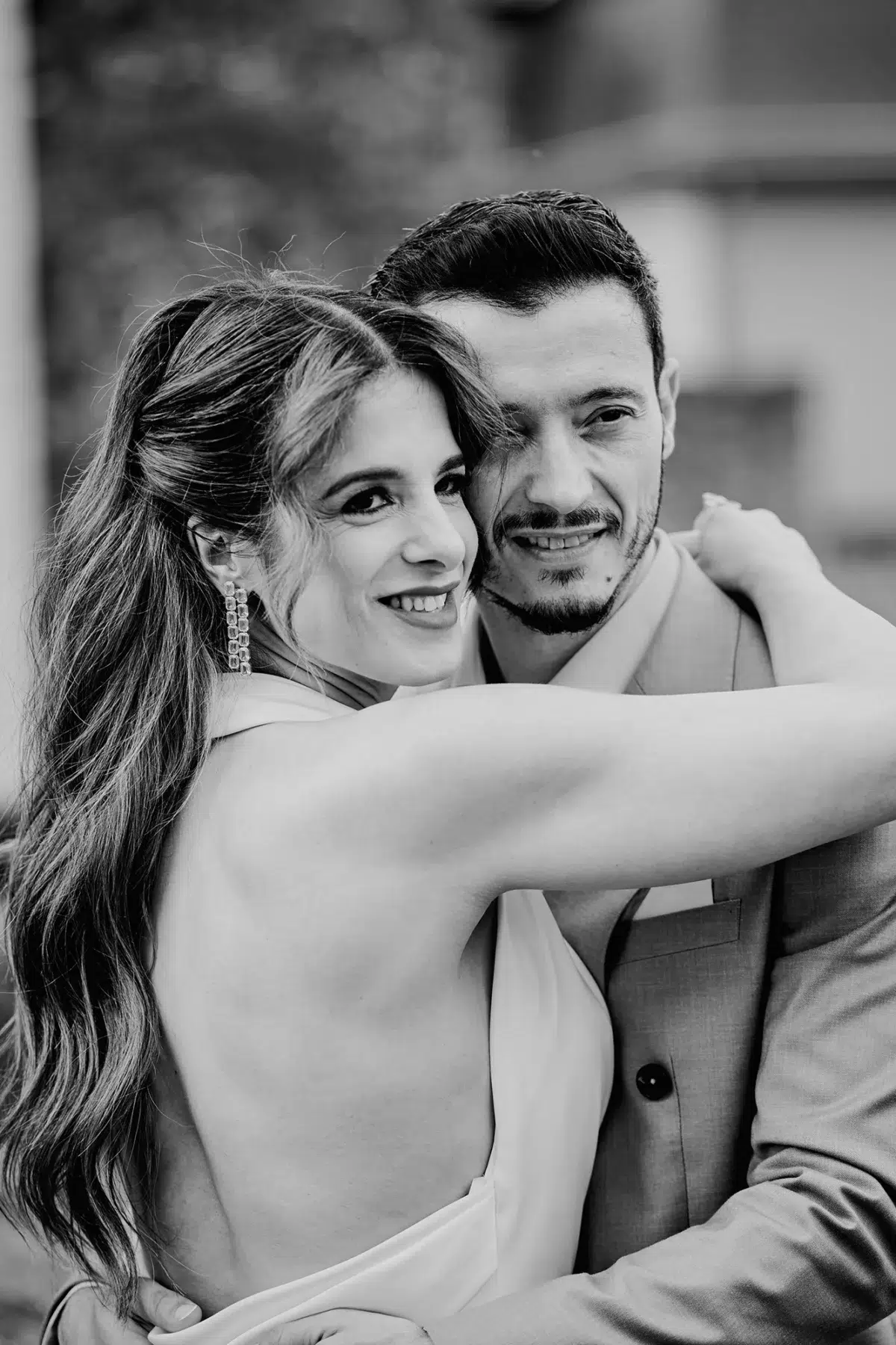 Black and white close-up portrait of a bride and groom smiling cheek to cheek, a soulful moment from an authentic Luxembourg wedding.