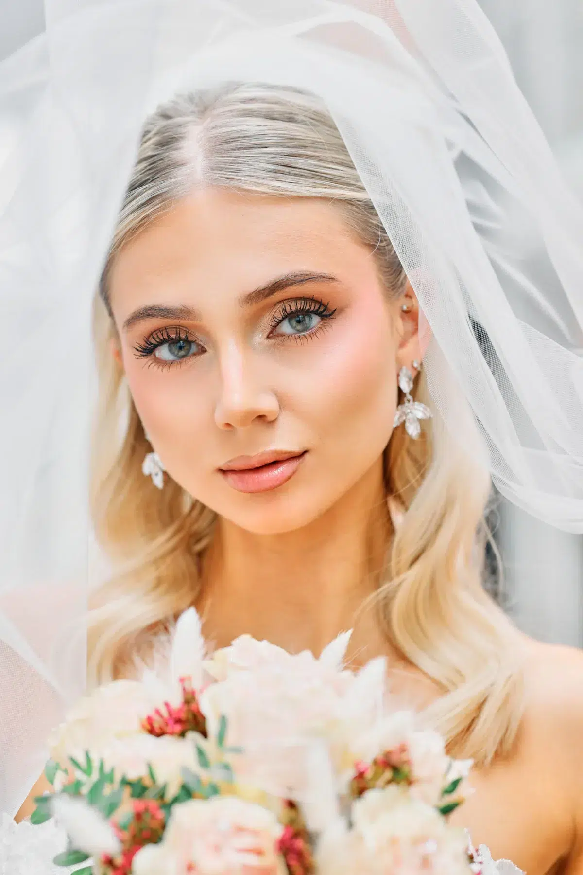 Close bridal portrait with the veil draped softly over the bride's face, Luxembourg wedding photography.