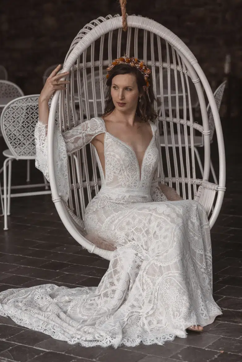 Bride in her wedding dress sitting on a garden swing at Château d'Urspelt, Clervaux, Luxembourg.
