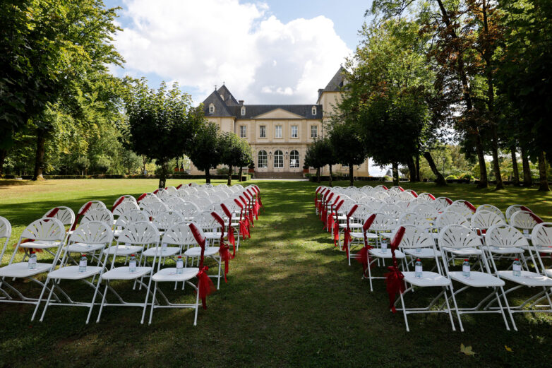 Outdoor wedding ceremony chairs set up on the lawn at Château du Bois d'Arlon